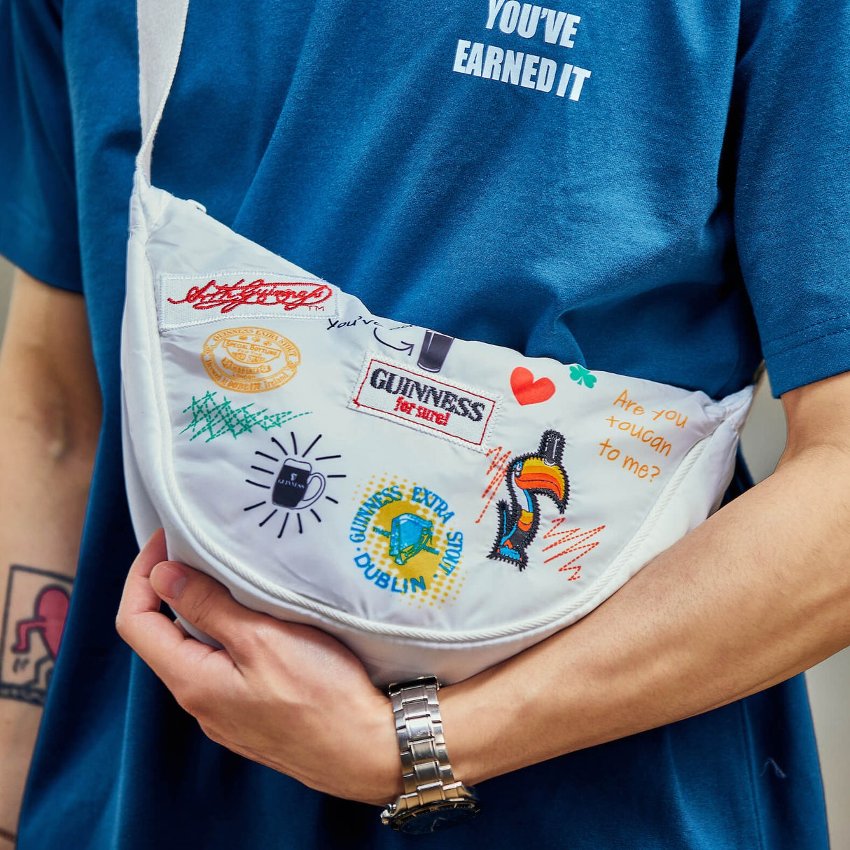 Detail shot of a man wearing the Guinness Storehouse, Dublin, Ireland, exclusive white belt bag.