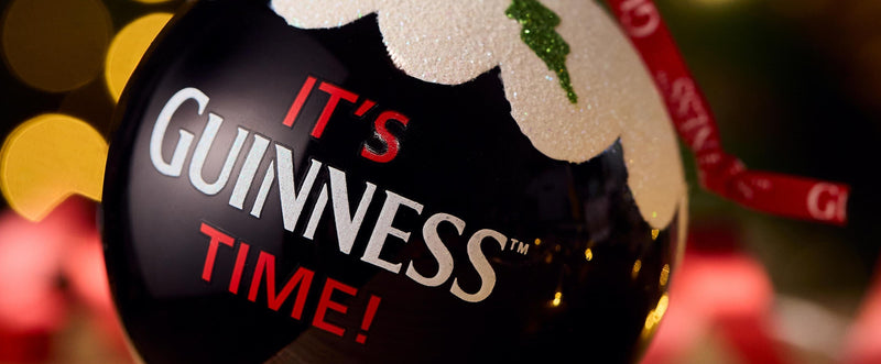 Guinness Christmas ornament with festive background