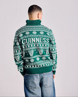 Person wearing a green Guinness sweater with a white background