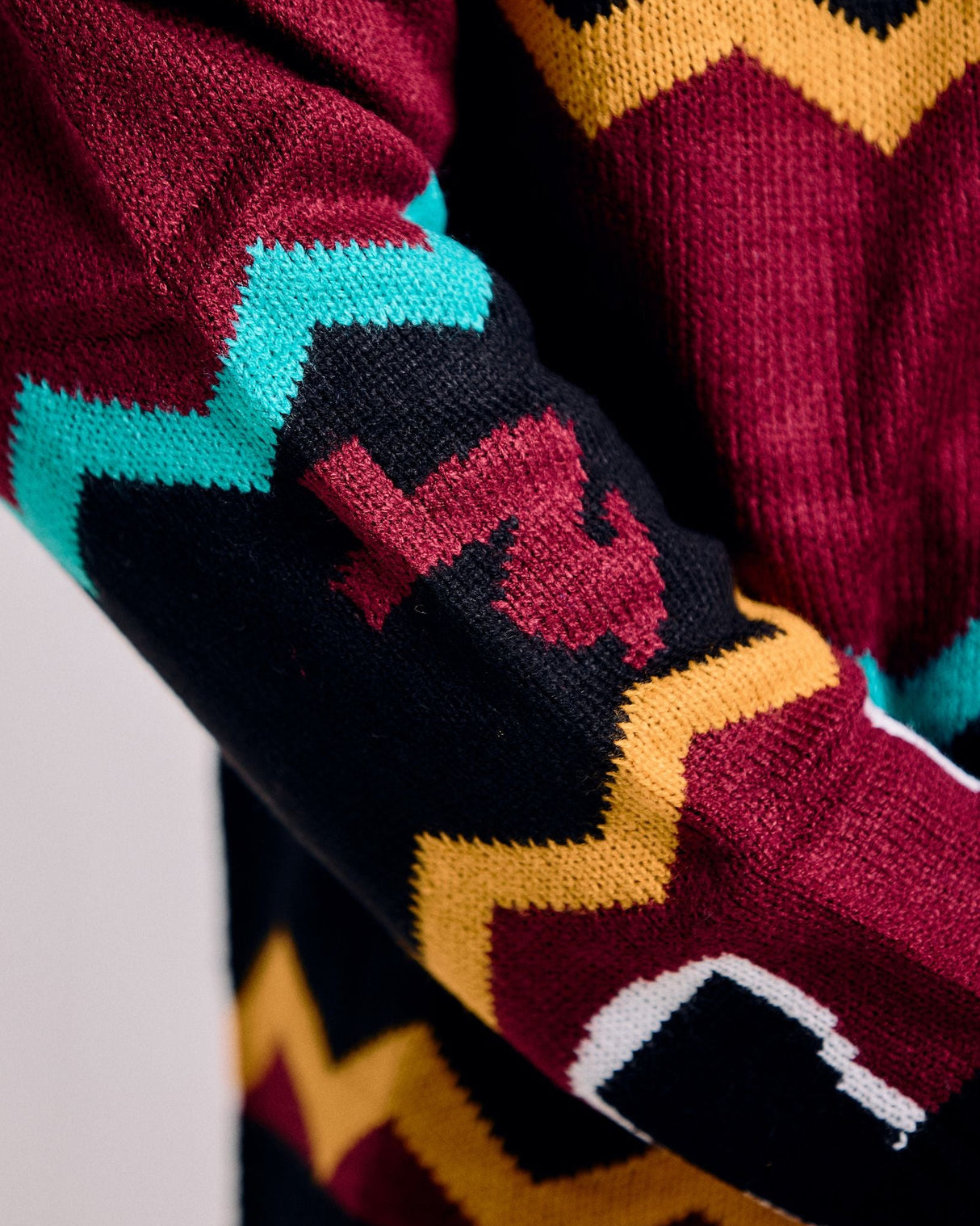 Close-up of colorful patterned socks with zigzag design on a neutral background