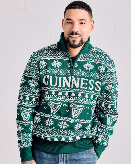 Man wearing a green Guinness sweater with a white background