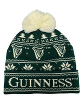 Green knit beanie with white patterns and pom-pom, featuring the Guinness logo on a white background.