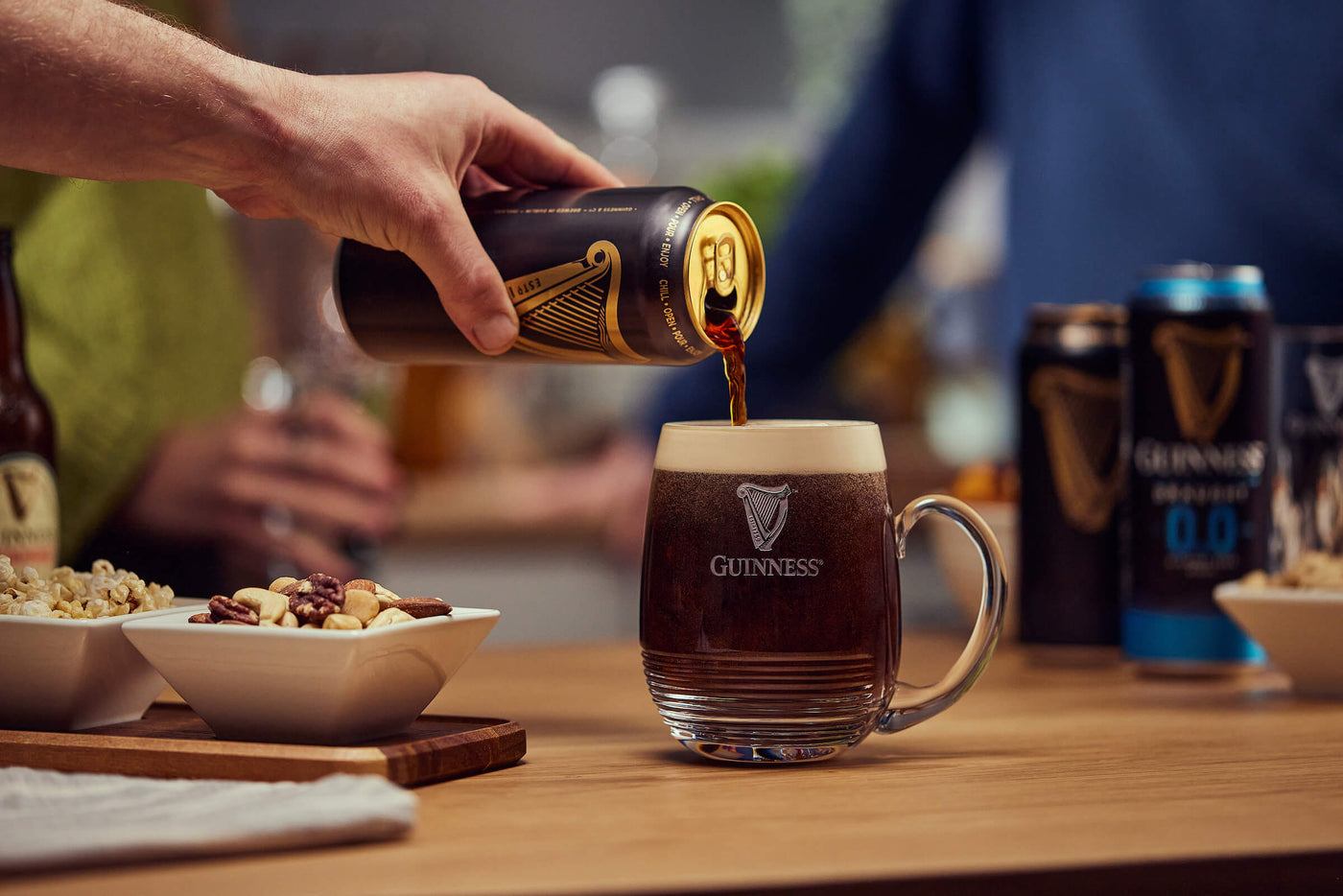 Hand pouring Guinness Drought Can in the world famous Guinness X Waterford Crystal Glass.