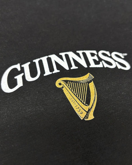 Guinness logo with harp on a black background