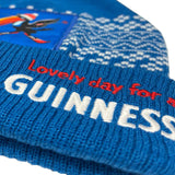 Blue knit beanie with 'Lovely day for a Guinness' text and pattern