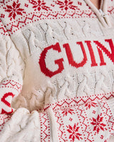 Close-up of a white sweater with red text and patterns