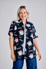 Person wearing a navy blue shirt with red and white graphics, standing against a light gray background.