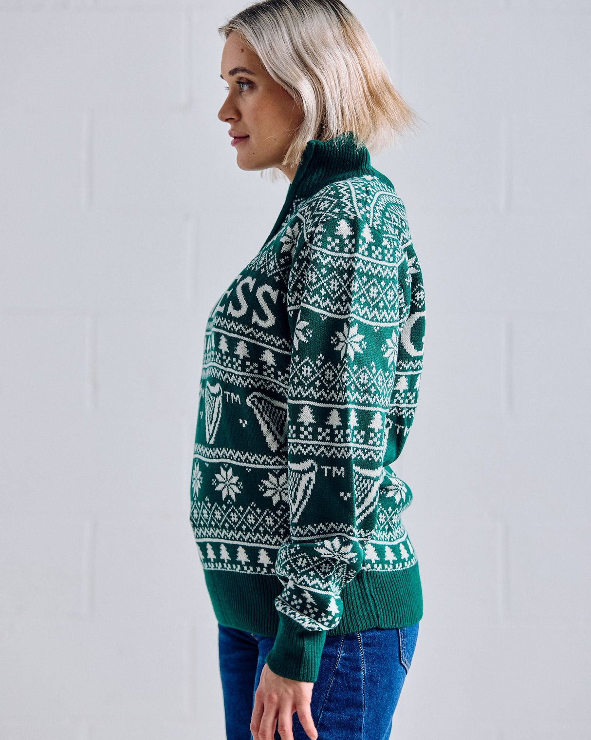 Woman wearing a green patterned sweater against a white background