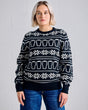 Person wearing a black sweater with white patterns against a gray background