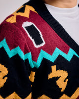 Close-up of a person wearing a colorful patterned sweater with a white shirt underneath.