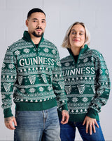 Two people wearing green Guinness sweaters against a light gray background
