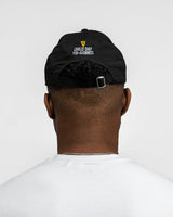 Person wearing a black cap with text on the back against a white background