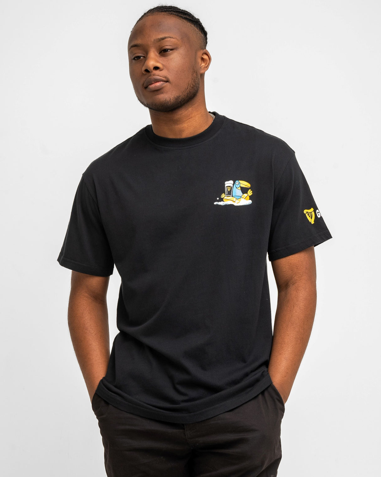 Man wearing a black t-shirt with a logo on a white background