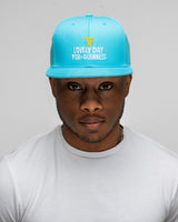 Person wearing a blue cap with text on a plain background