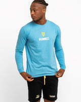 Person wearing a blue long-sleeve shirt with a Guinness logo on a white background