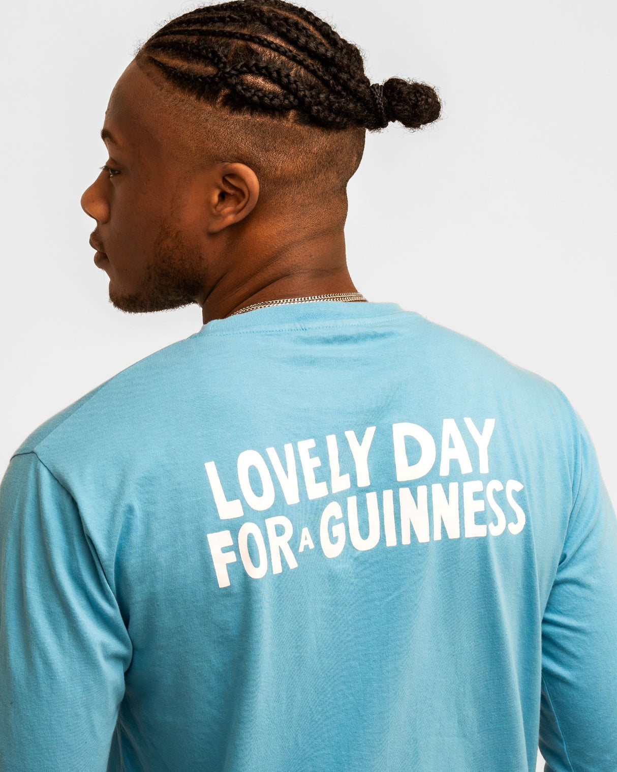 Person wearing a blue shirt with 'Lovely Day for a Guinness' text on the back.
