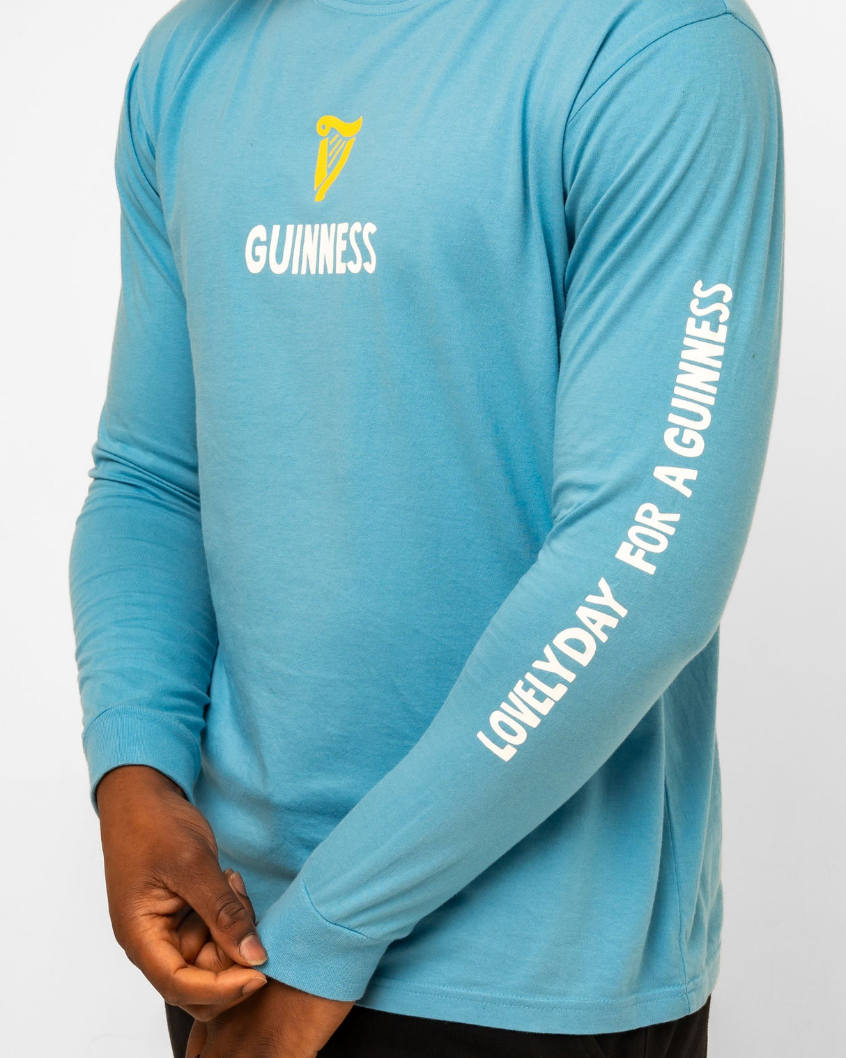 Blue long-sleeve shirt with Guinness branding on a white background