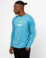 Man wearing a blue Guinness long-sleeve shirt and black shorts on a white background