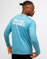 Man wearing a blue long-sleeve shirt with text on the back against a white background