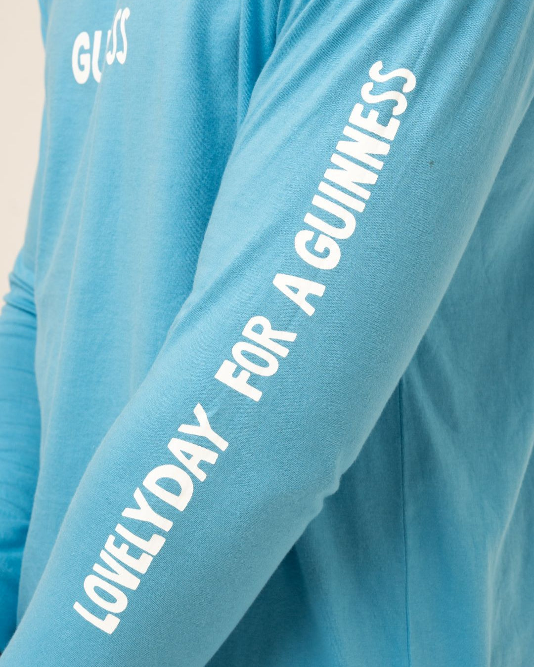 Blue shirt with text 'LOVELY DAY FOR A GUINNESS' on a plain background