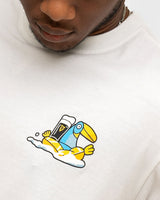 White t-shirt with a colorful toucan graphic on a plain background
