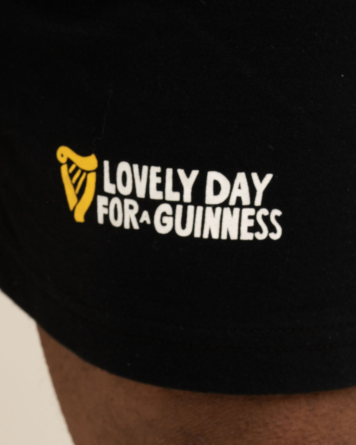 Black shirt with 'Lovely Day for a Guinness' text and logo on a plain background
