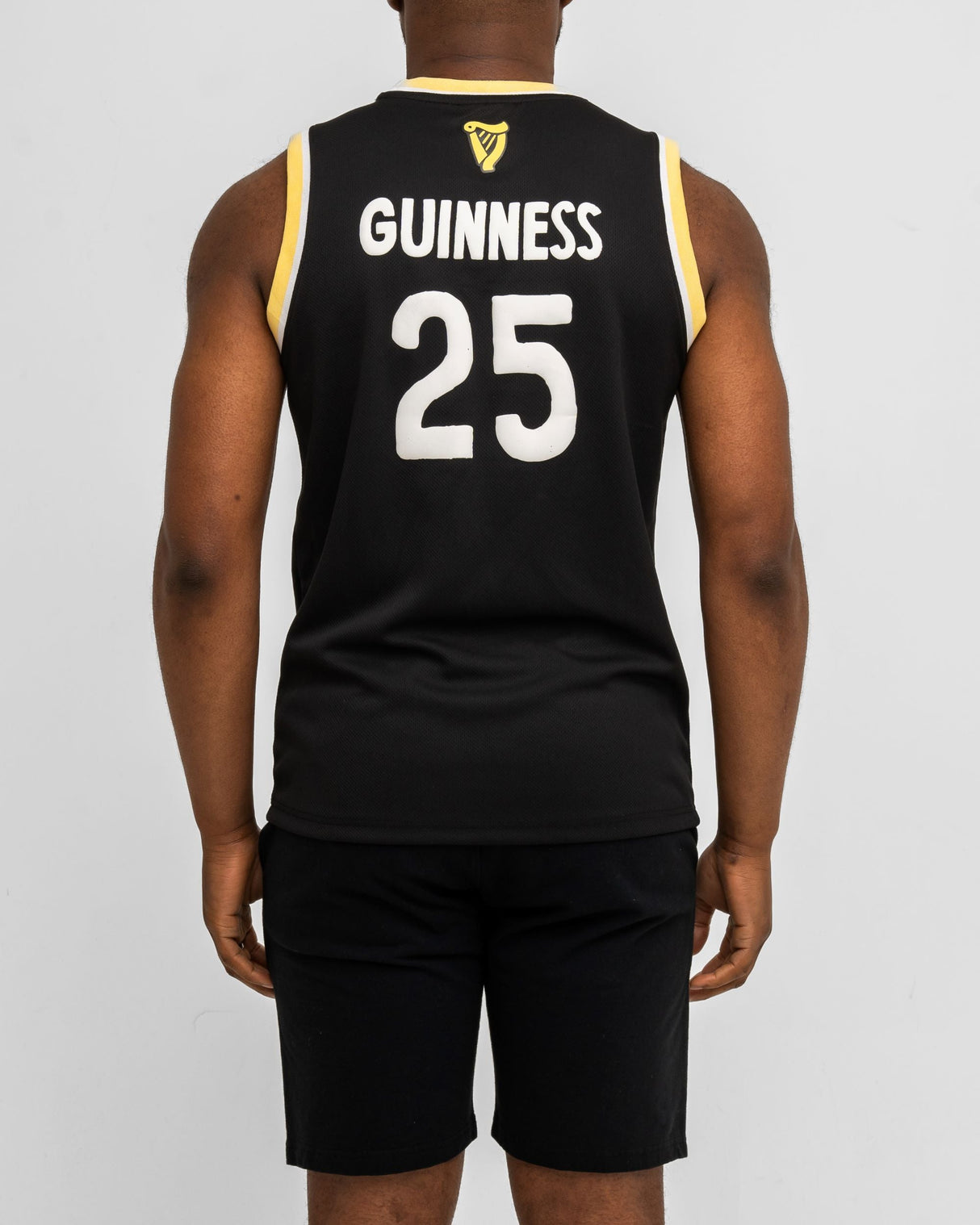 Person wearing a black sports jersey with 'Guinness' and number '25' on the back, against a white background.