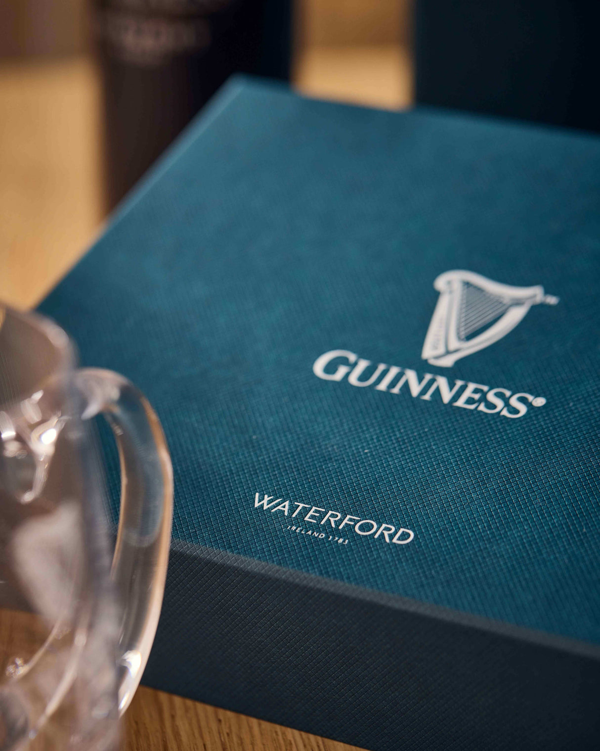 Clear glass mug with a blue Guinness branded box in the background
