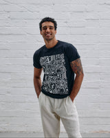 Model wearing the Guinness Storehouse Exclusive black t-shirt with stylized Dublin map.