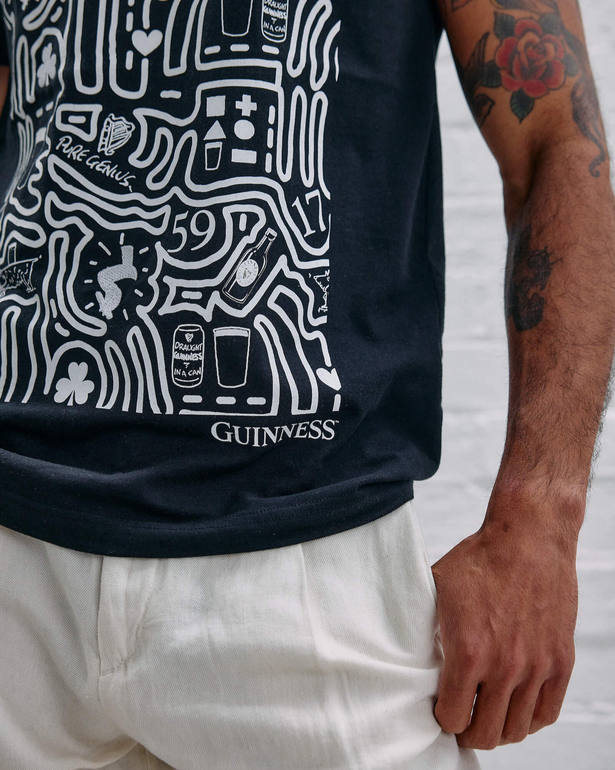 Model wearing the Guinness Storehouse Exclusive black t-shirt with stylized Dublin map.