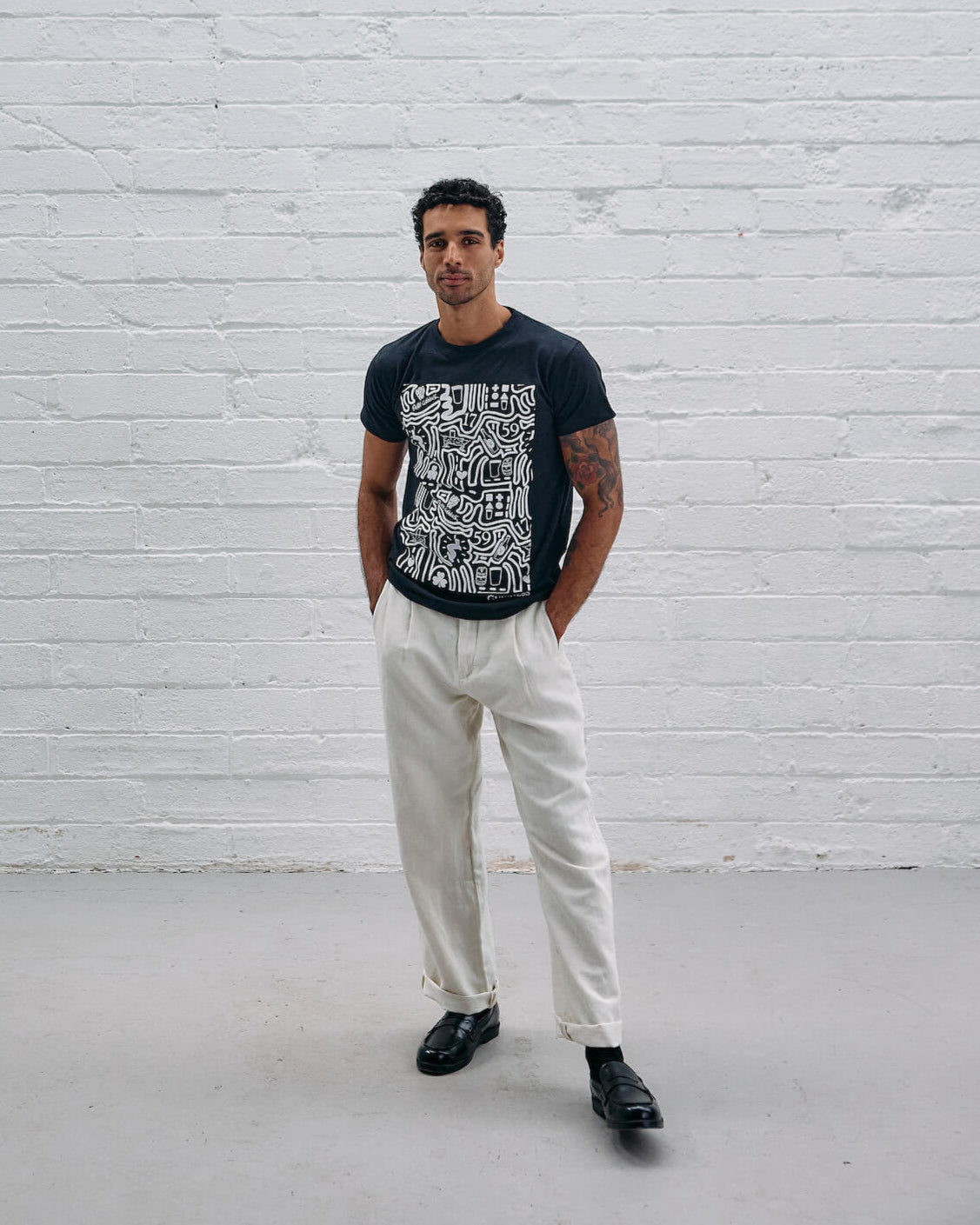 Model wearing the Guinness Storehouse Exclusive black t-shirt with stylized Dublin map.