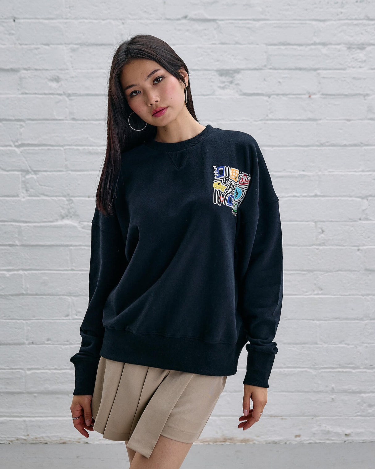 Model wearing the Guinness Storehouse Exclusive Black Sweter with stylized Dublin map.