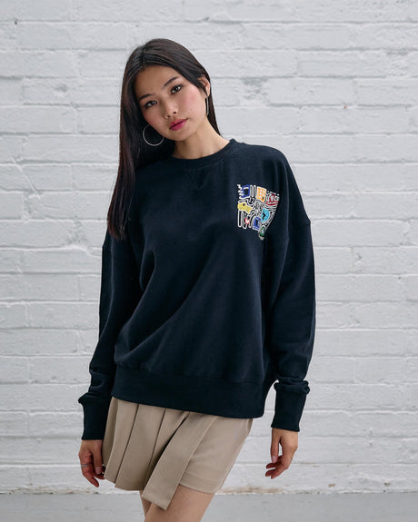 Model wearing the Guinness Storehouse Exclusive Black Sweter with stylized Dublin map.