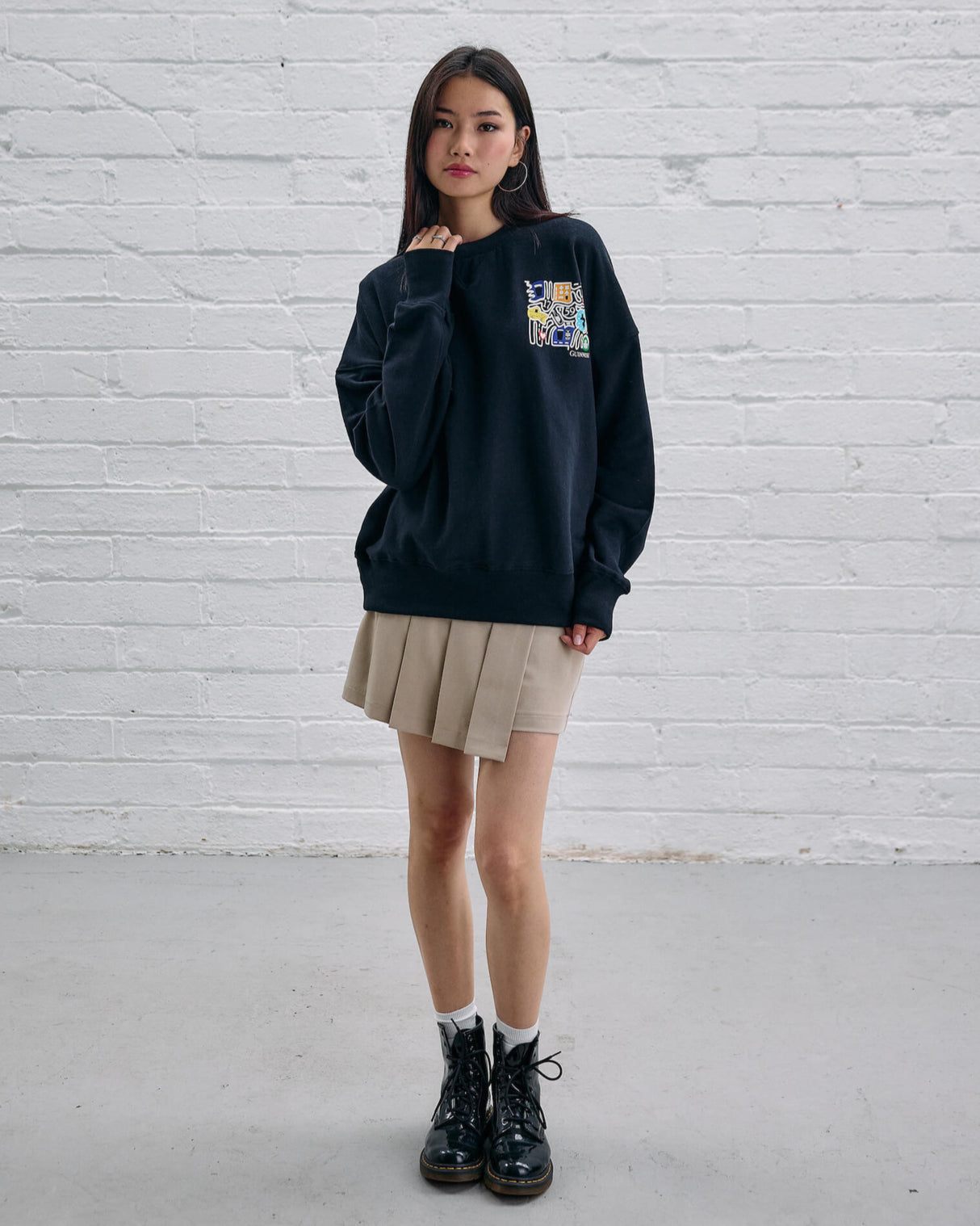 Model wearing the Guinness Storehouse Exclusive Black Sweter with stylized Dublin map.