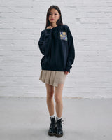 Model wearing the Guinness Storehouse Exclusive Black Sweter with stylized Dublin map.