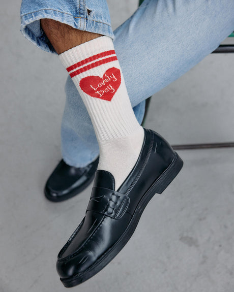 Image of the lovely day heart socks worn by a model.