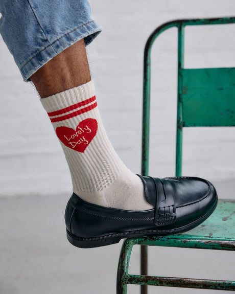 Image of the lovely day heart socks worn by a model.