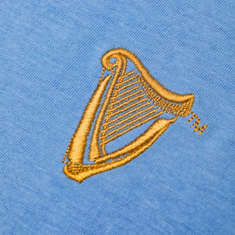 Detail of the Guinness Storehouse Exclusive, light blue, chest harp t-shirt.