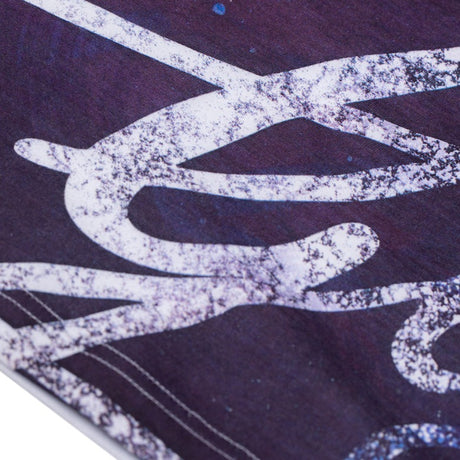 Detail of the Guinness Storehouse Exclusive t-shirt, inspired by the new Guinness brand book, featuring the iconic golden harp and the beautiful purple texture with Arthur Guinness signature. 