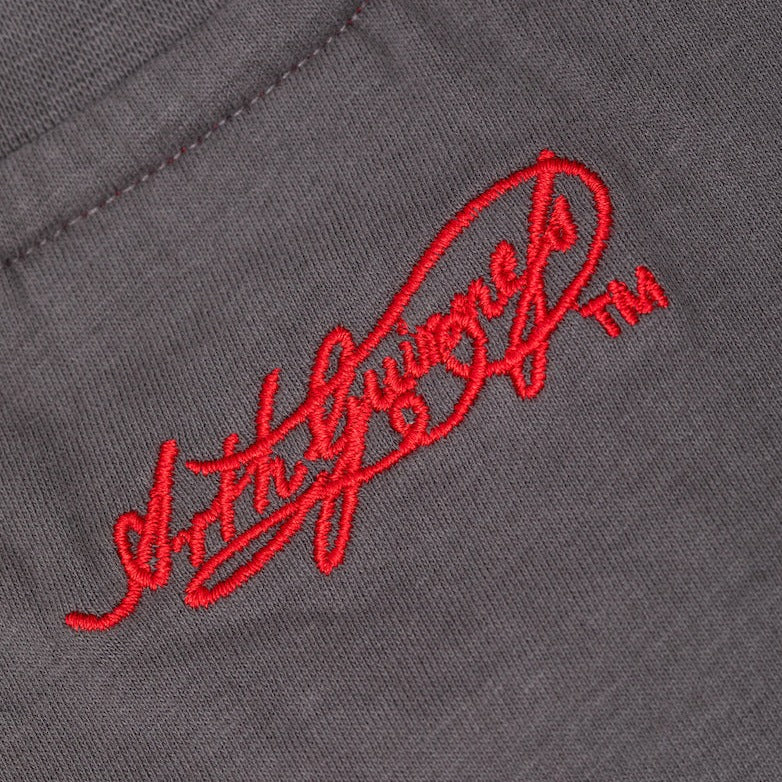 Detail of the Guinness Storehouse Exclusive dark grey t-shirt's  Arthur Guinness red signature. 